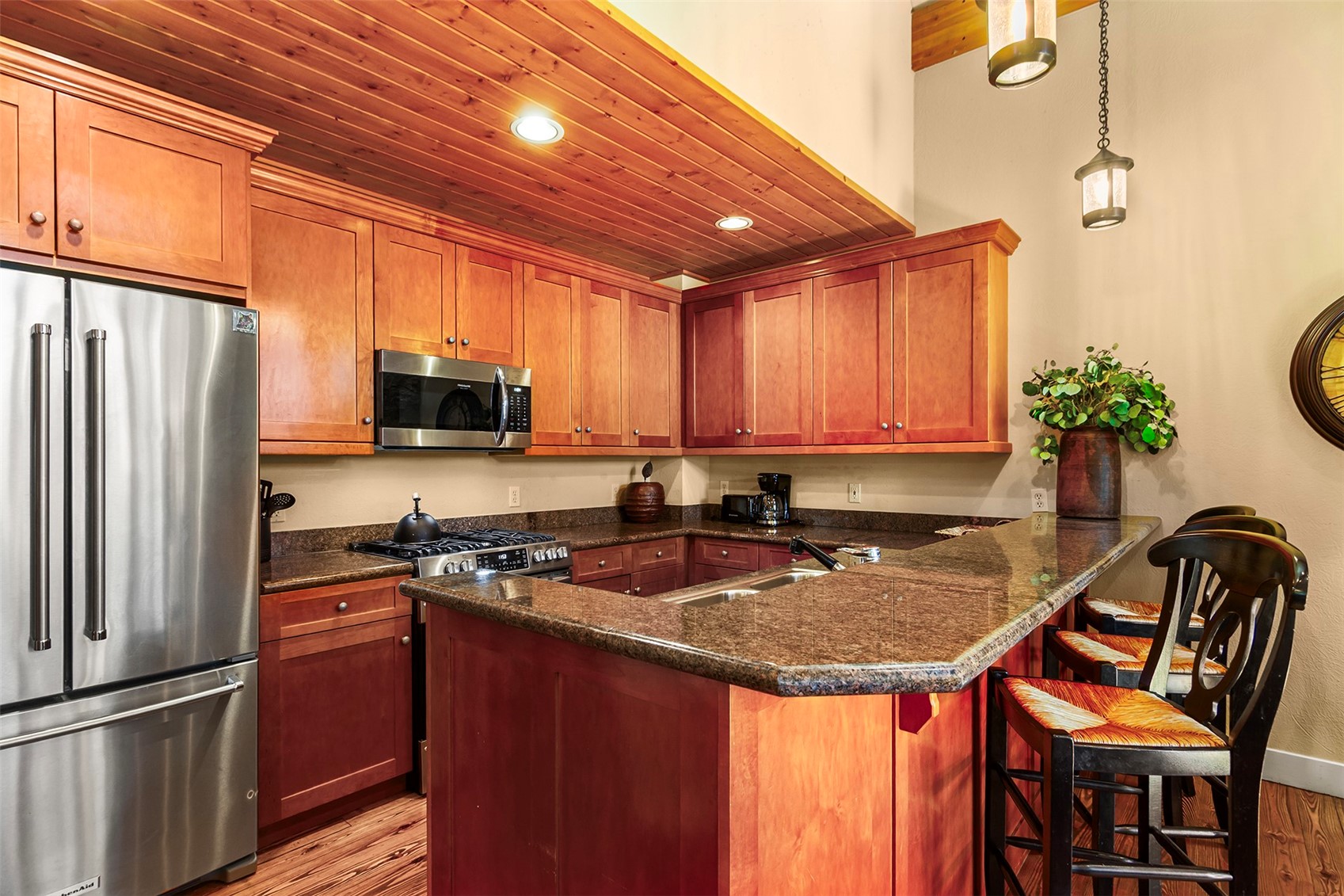 55 Westridge Road, Unit 55 Breckenridge, CO 80424 - Photo 8 of 42 a kitchen with stainless steel appliances granite countertop a stove a refrigerator a sink dishwasher with a dining table and chairs