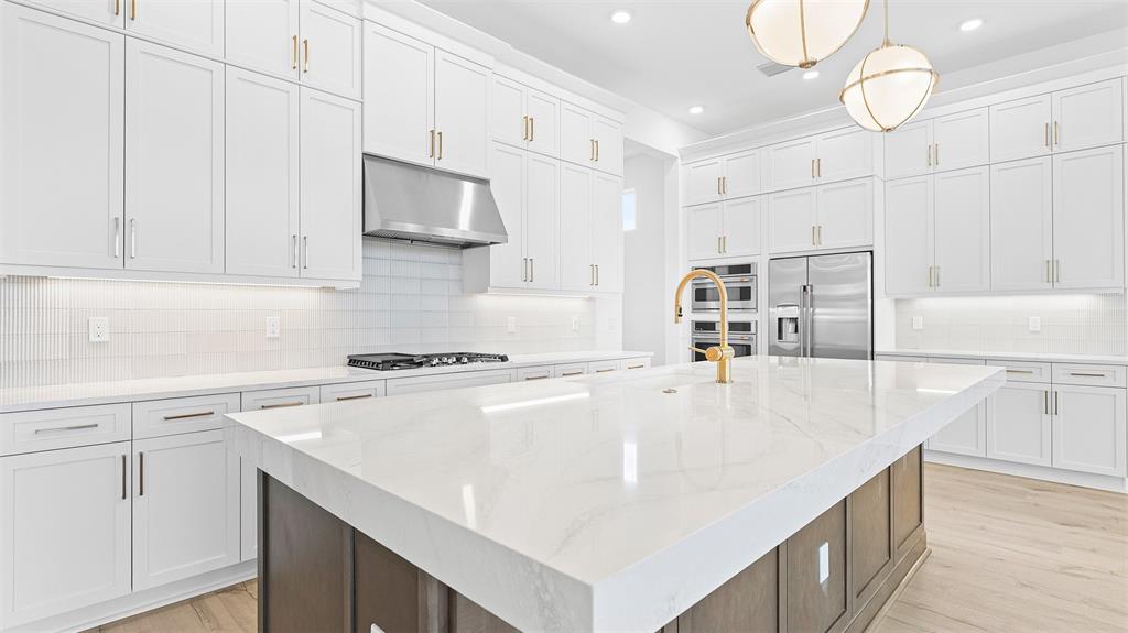 5237 Rivo Alto Circle Westlake, FL 33470 - Photo 12 of 63 a kitchen with kitchen island a white counter top space cabinets and stainless steel appliances