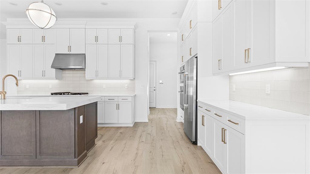 5237 Rivo Alto Circle Westlake, FL 33470 - Photo 14 of 63 a kitchen with cabinets and wooden floor