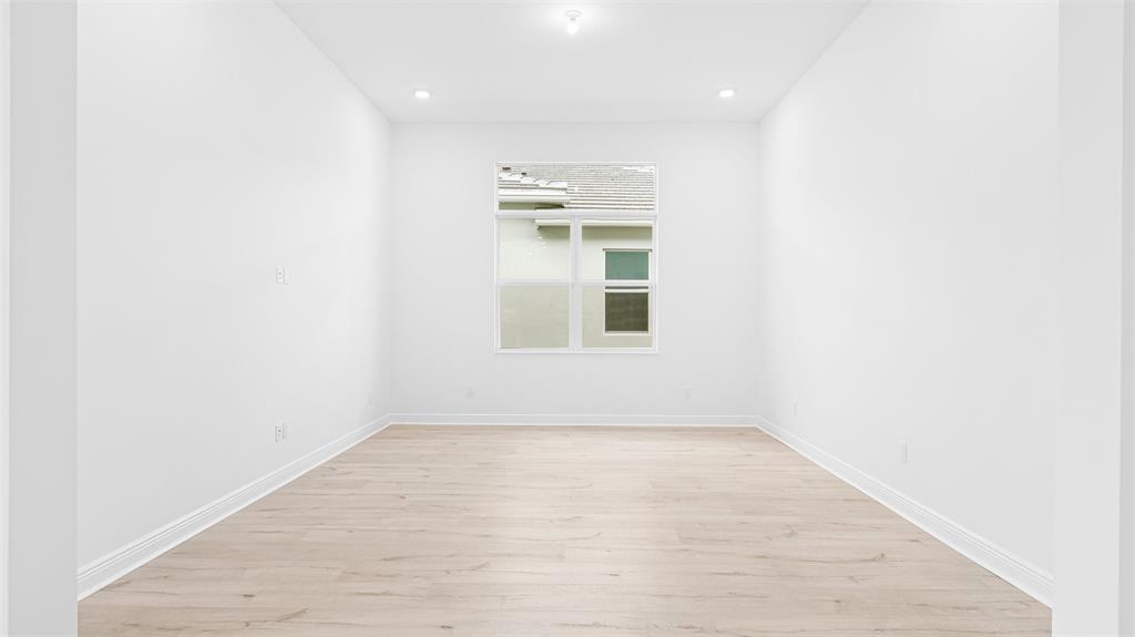 5237 Rivo Alto Circle Westlake, FL 33470 - Photo 17 of 63 a view of empty room with wooden floor and fan