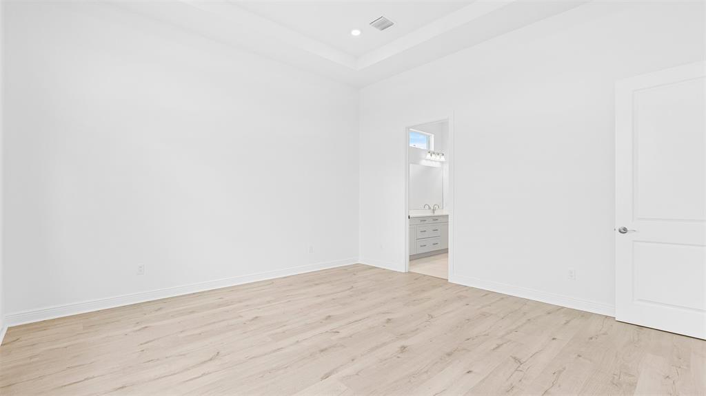 5237 Rivo Alto Circle Westlake, FL 33470 - Photo 20 of 63 an empty room with wooden floor and bathroom