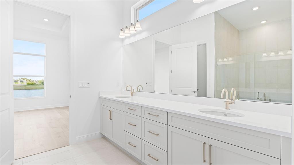5237 Rivo Alto Circle Westlake, FL 33470 - Photo 21 of 63 a bathroom with double sink and a mirror