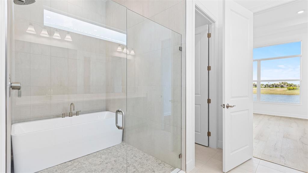 5237 Rivo Alto Circle Westlake, FL 33470 - Photo 22 of 63 a bathroom with a bathtub and shower