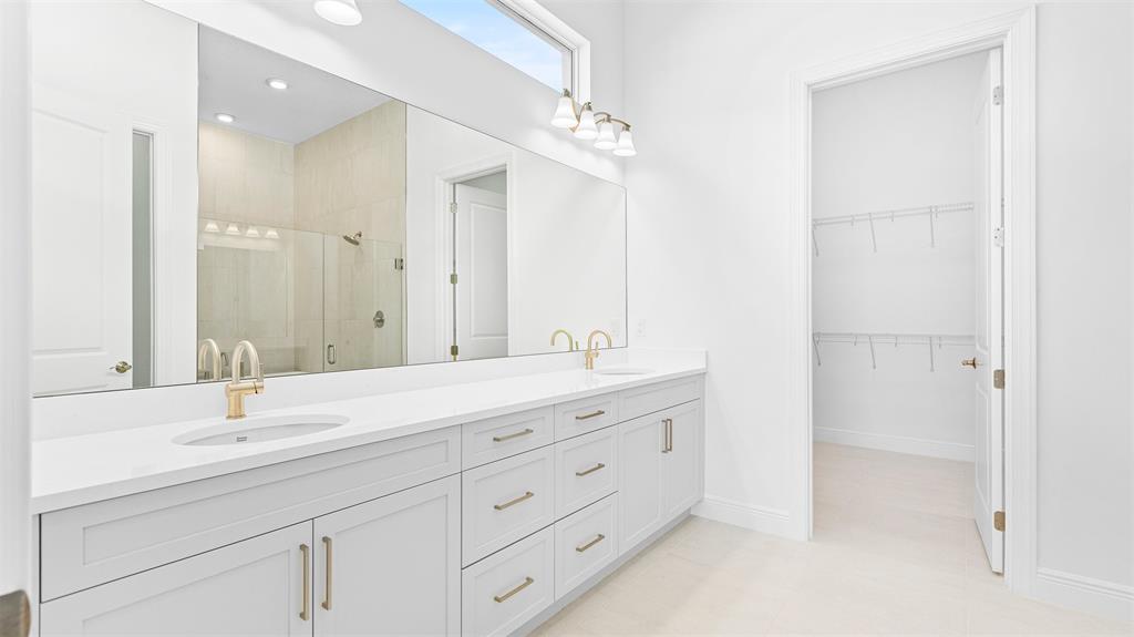 5237 Rivo Alto Circle Westlake, FL 33470 - Photo 25 of 63 a bathroom with a double vanity sink and a mirror
