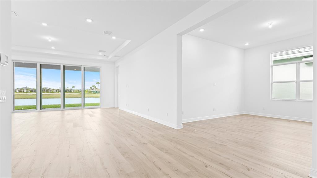 5237 Rivo Alto Circle Westlake, FL 33470 - Photo 5 of 63 a view of an empty room with wooden floor and a window