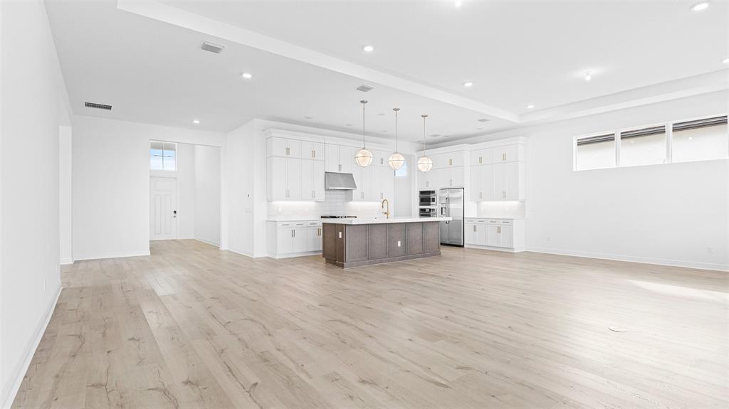 5237 Rivo Alto Circle Westlake, FL 33470 - Photo 6 of 63 a view of a kitchen with white cabinets and wooden floors