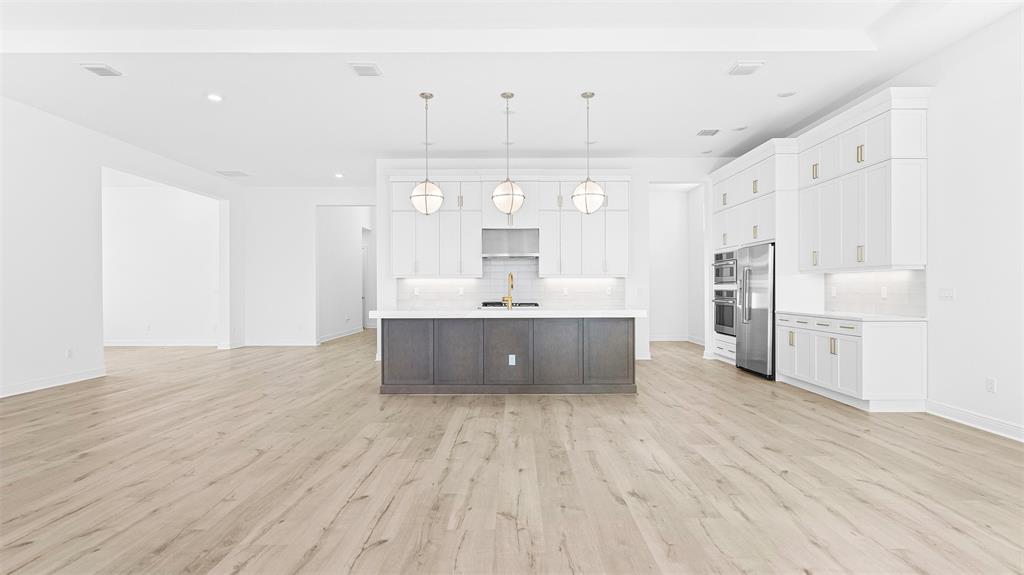 5237 Rivo Alto Circle Westlake, FL 33470 - Photo 8 of 63 a large white kitchen with cabinets a sink and a stove