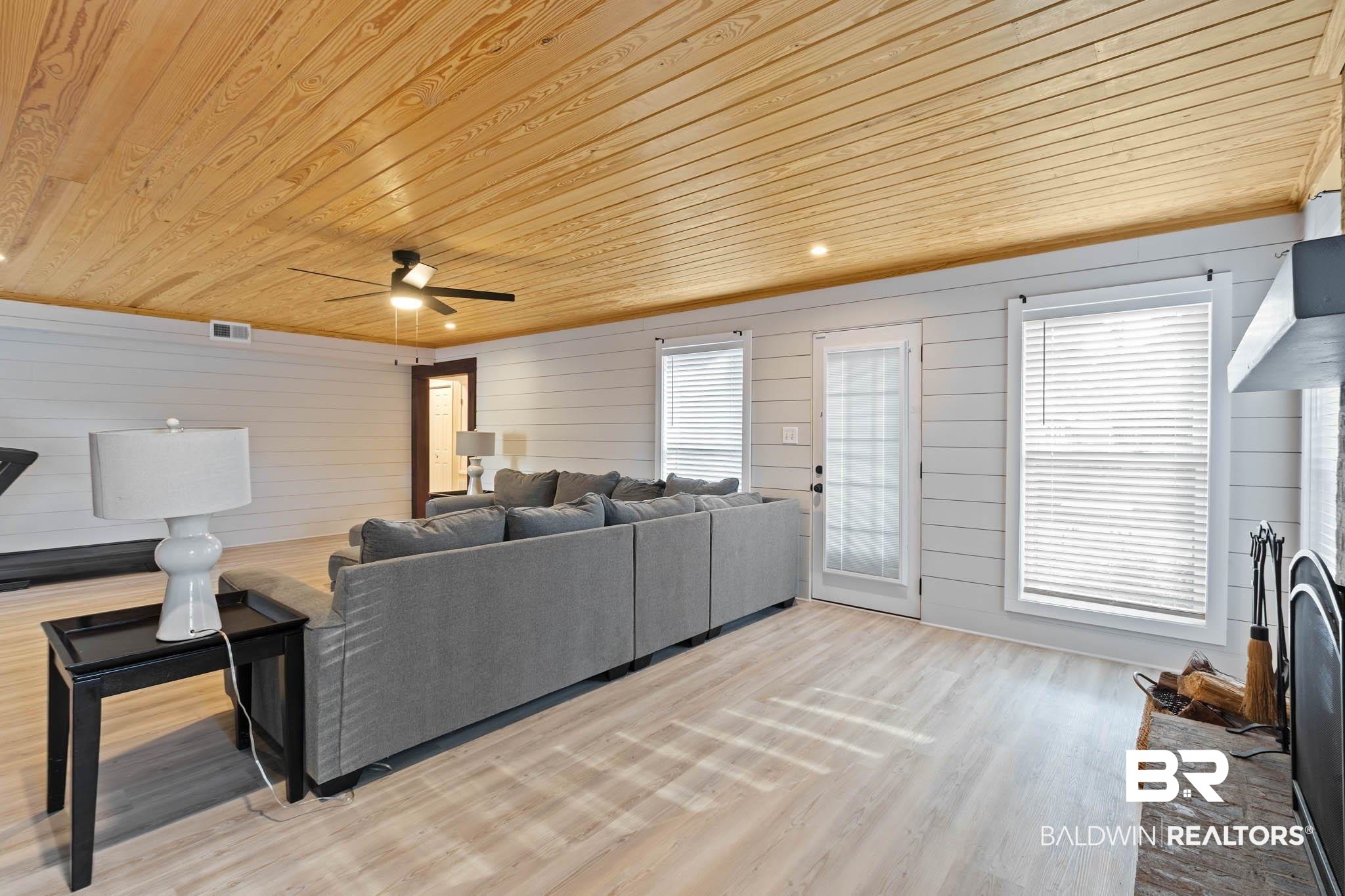 608 Southern Way Daphne, AL 36527 - Photo 14 of 35 Living room with wood ceiling, wooden walls, light wood finished floors, and a fireplace