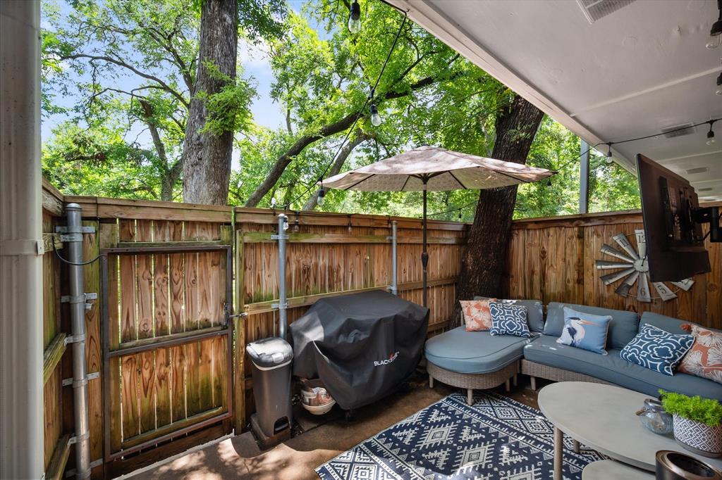 1379 Roaring Springs Road Fort Worth, TX 76114 - Photo 9 of 36 Covered patio featuring a wood privacy fence and mature trees
