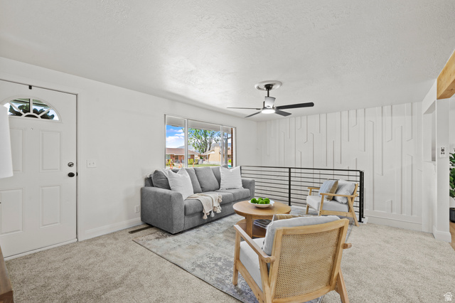 2267 West 4350th Street South Roy, UT 84067 - Photo 6 of 32 Carpeted living area with ceiling fan and a textured ceiling