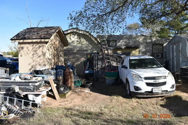 a view of a patio with table and chairs under an umbrella