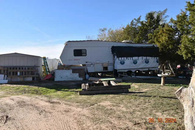 a front view of a house with a yard covered with snow