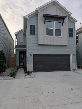 a front view of a house with yard and parking