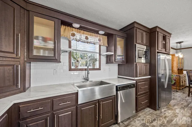 a kitchen with stainless steel appliances granite countertop counter space a sink and cabinets