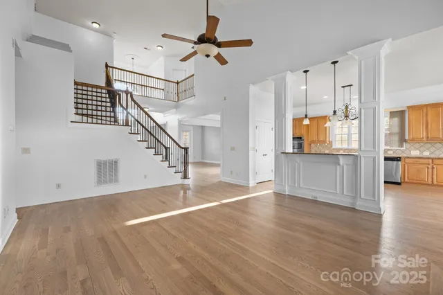 a view of a kitchen with wooden floor and a kitchen space