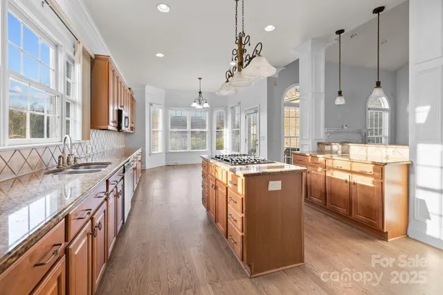 a large kitchen with stainless steel appliances kitchen island granite countertop a large counter top and stainless steel appliances