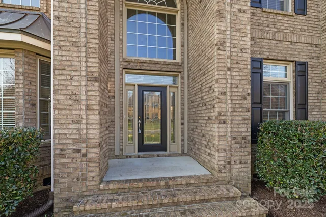 a view of front door of house with stairs