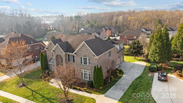 an aerial view of a house with a yard