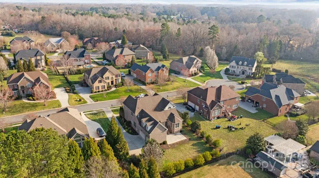 an aerial view of a houses with a swimming pool
