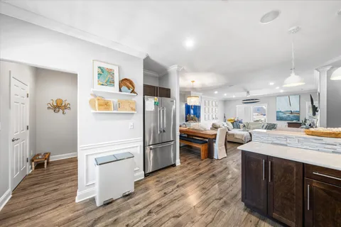 a kitchen with stainless steel appliances kitchen island granite countertop a refrigerator and a stove top oven