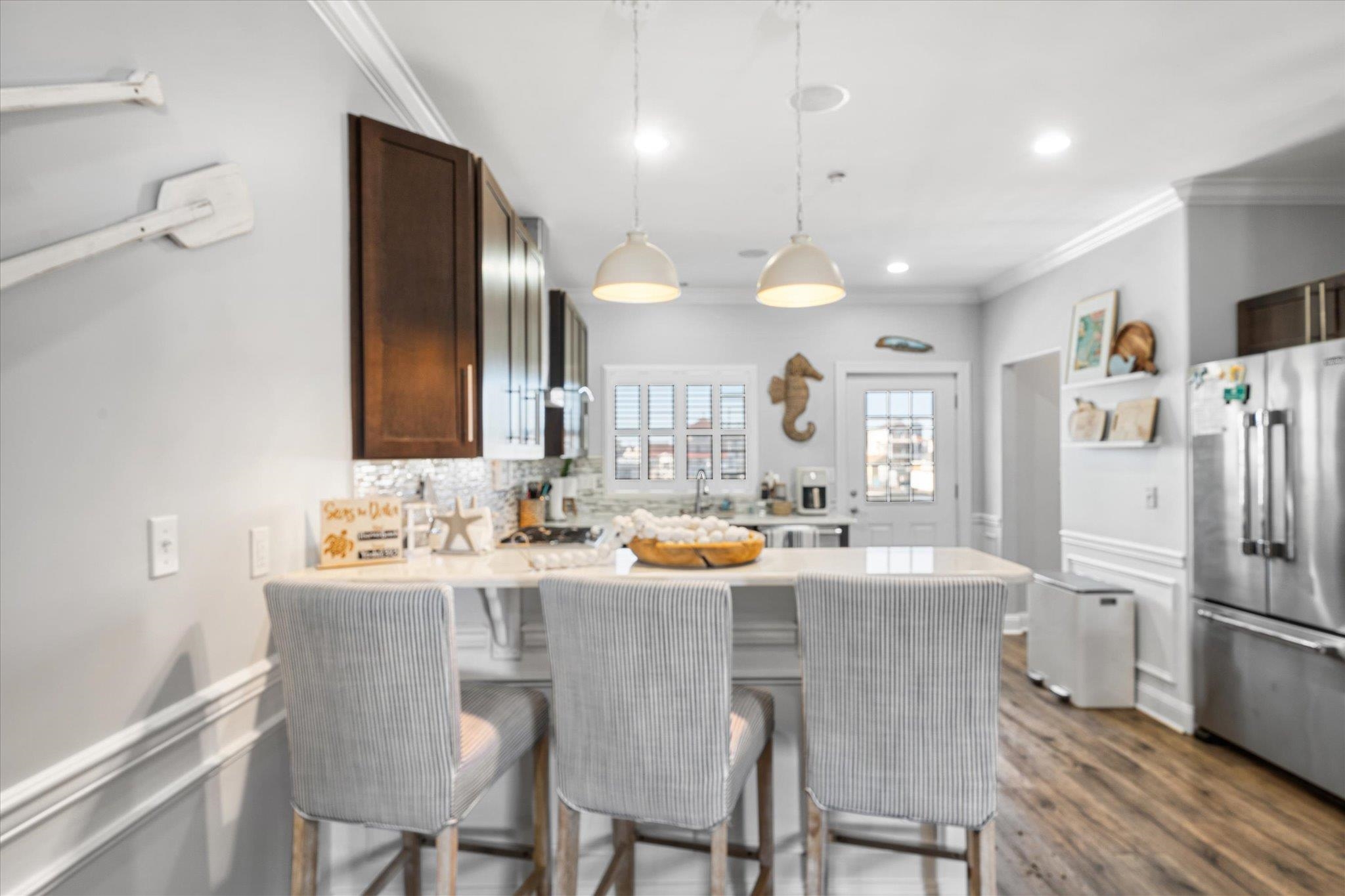 110 West Walnut Avenue, Unit 103 North Wildwood, NJ 08260 - Photo 14 of 44 a dining room with stainless steel appliances kitchen island granite countertop a dining table and chairs