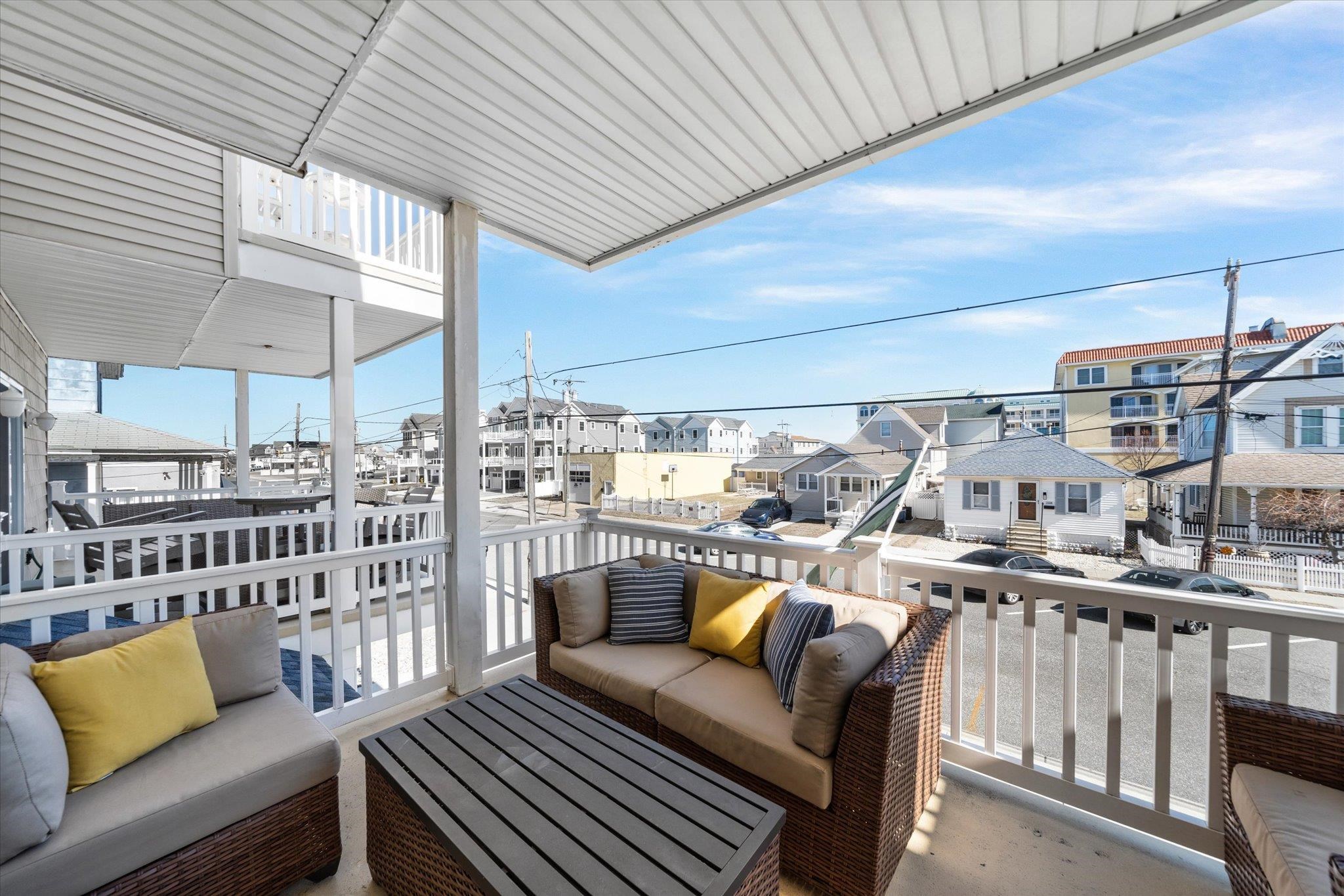 110 West Walnut Avenue, Unit 103 North Wildwood, NJ 08260 - Photo 23 of 44 a roof deck with a couch and chairs