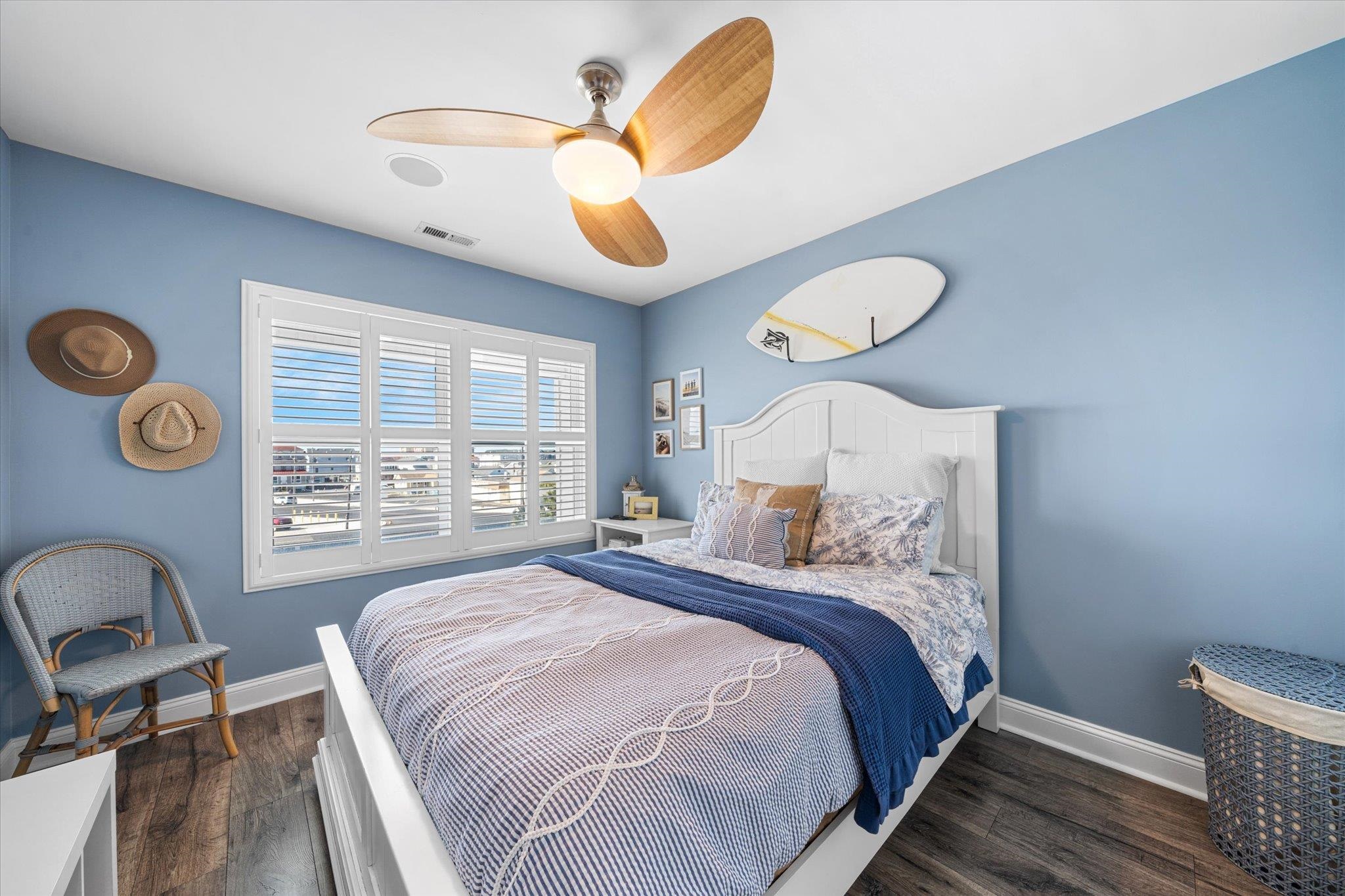 110 West Walnut Avenue, Unit 103 North Wildwood, NJ 08260 - Photo 27 of 44 a bedroom with a bed and a chandelier