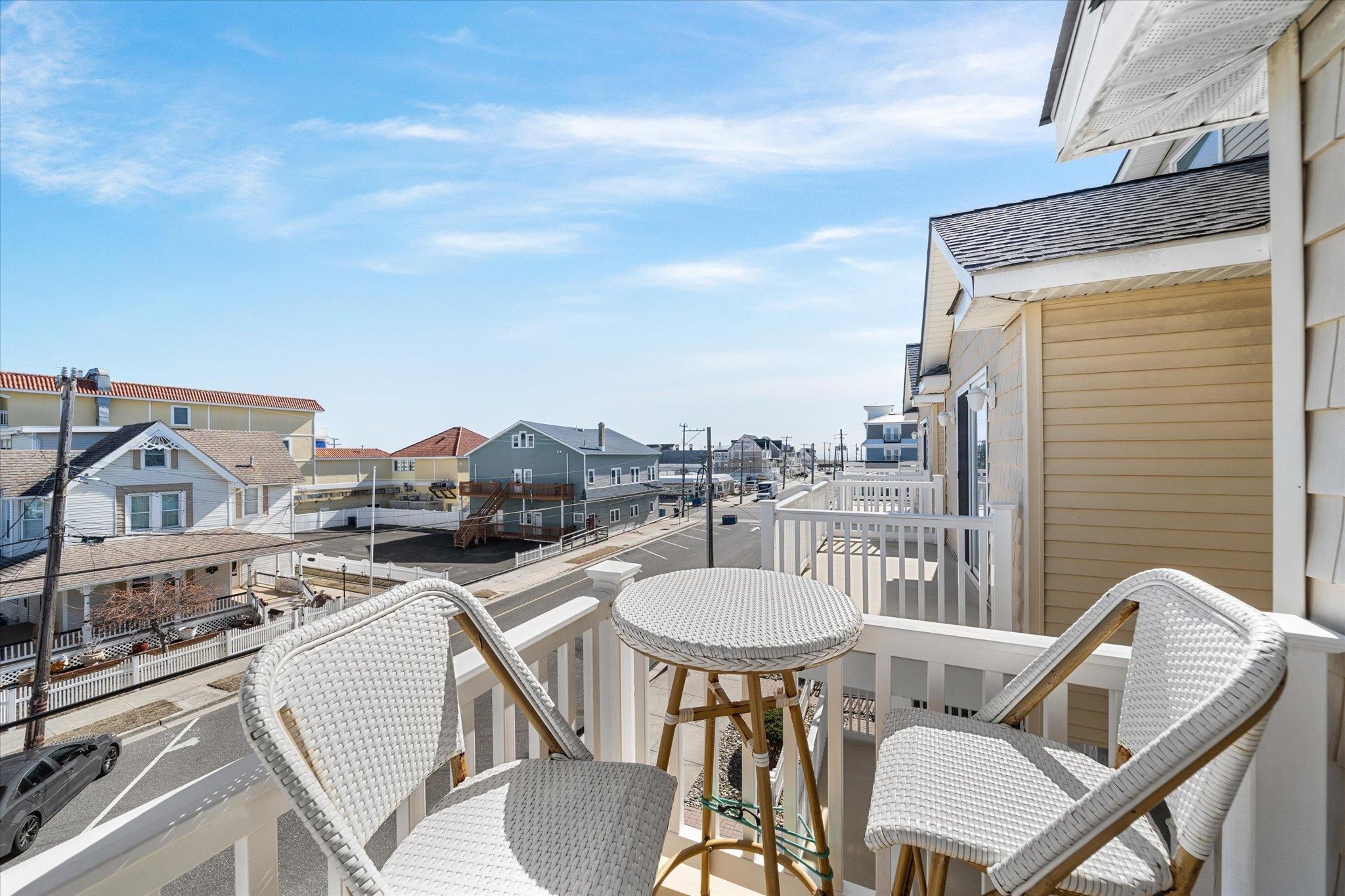 110 West Walnut Avenue, Unit 103 North Wildwood, NJ 08260 - Photo 36 of 44 a balcony with table and chairs