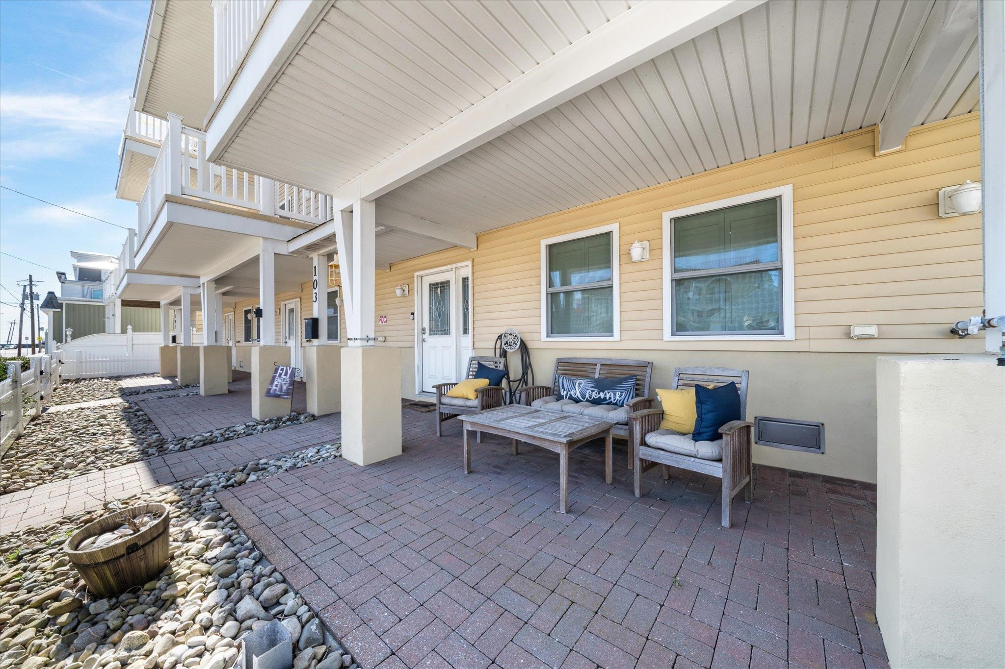 110 West Walnut Avenue, Unit 103 North Wildwood, NJ 08260 - Photo 6 of 44 a living room with couches and kitchen view with wooden floor