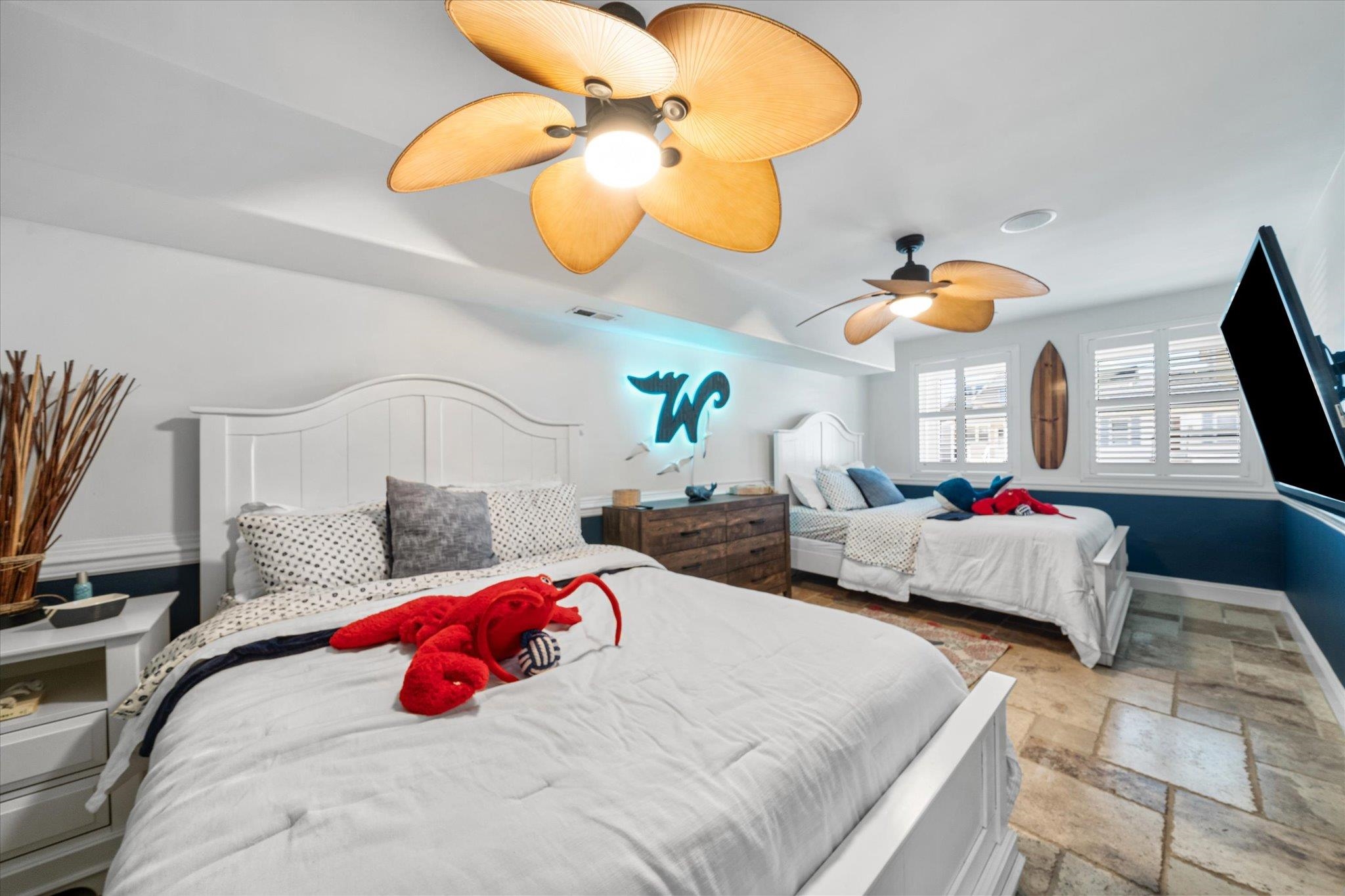 110 West Walnut Avenue, Unit 103 North Wildwood, NJ 08260 - Photo 8 of 44 a bedroom with two beds and a chandelier