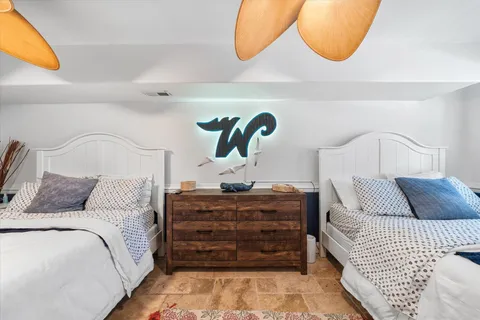 a bedroom with a bed and lamp