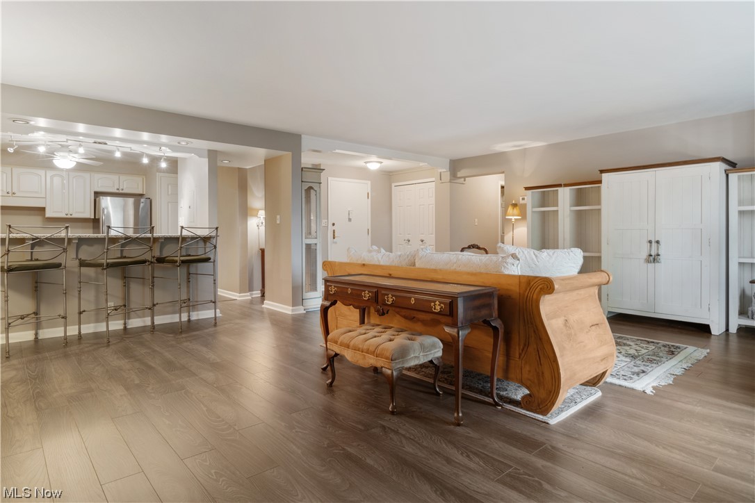 22555 Center Ridge Road, Unit 303 Rocky River, OH 44116 - Photo 11 of 33 Kitchen featuring stainless steel refrigerator, light countertops, white cabinetry, and light hardwood flooring