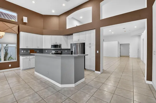 a kitchen with stainless steel appliances a refrigerator and a stove top oven