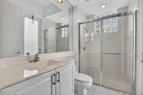 a view of empty room with wooden floor and floor to ceiling window