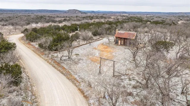 an aerial view of a house with a yard