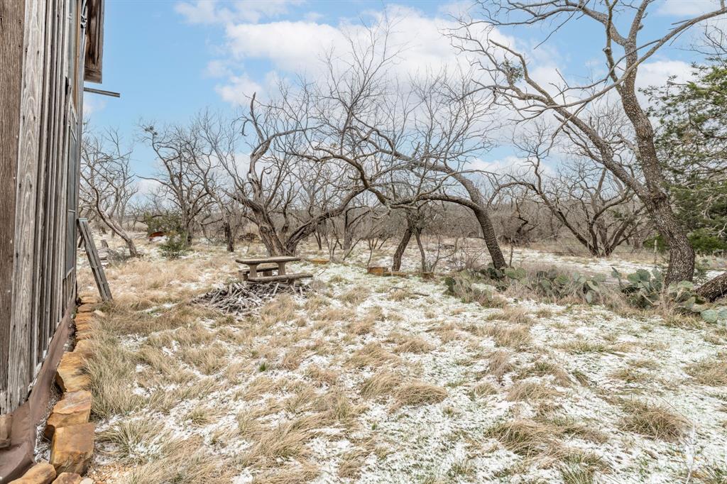 14459 County Road 107 Mingus, TX 76463 - Photo 6 of 40 a view of a yard covered with snow