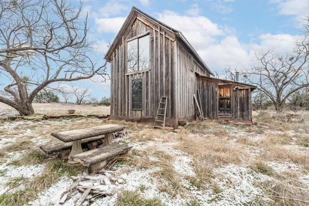 14459 County Road 107 Mingus, TX 76463 - Photo 7 of 40 a backyard of a house with barbeque oven and wooden fence