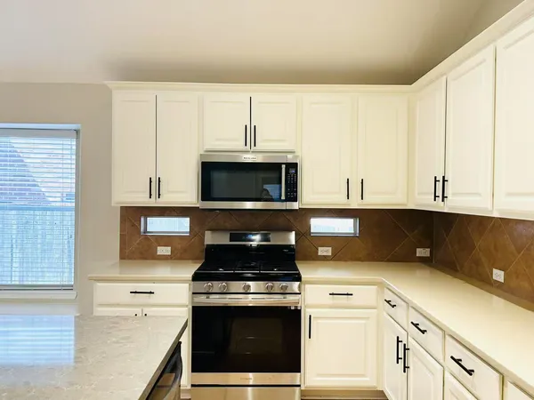 a kitchen with cabinets and appliances