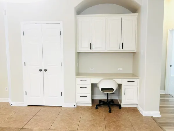 a view of an empty room with cabinet