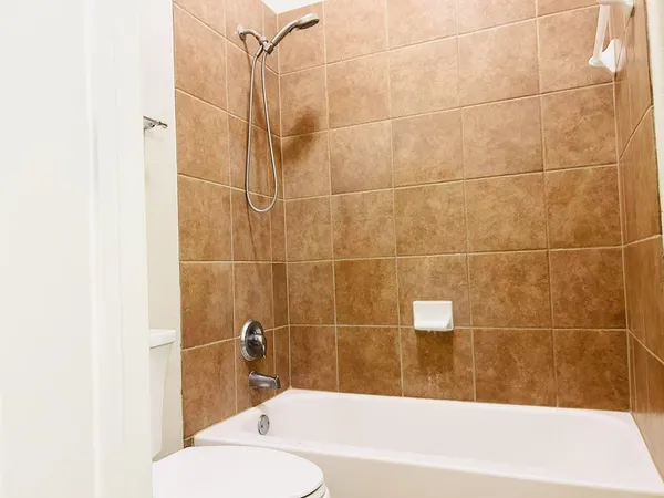 a bathroom with a bathtub and shower