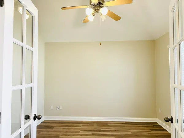 a view of room with window and wooden floor