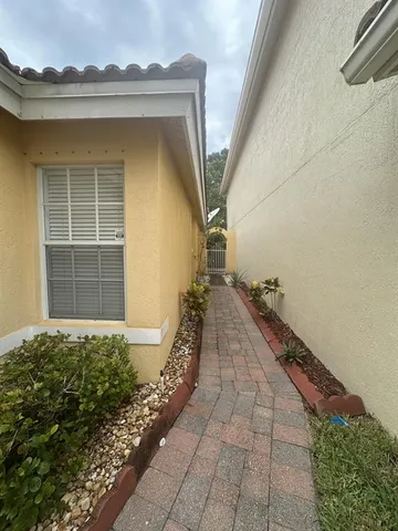 a view of a pathway with a house in the background