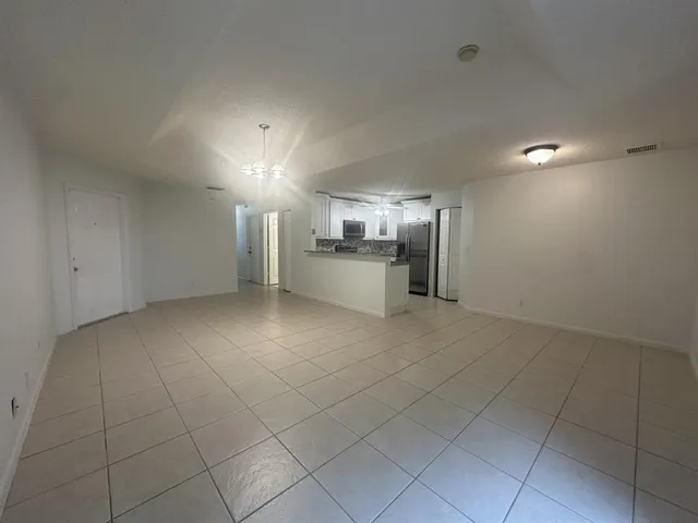 an empty room with a kitchen