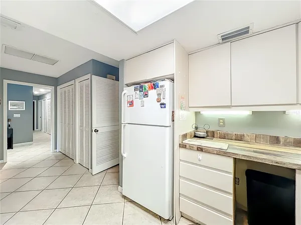 a white refrigerator freezer sitting in a kitchen