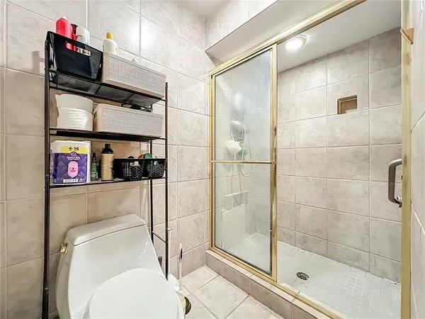 a bathroom with a toilet and a shower