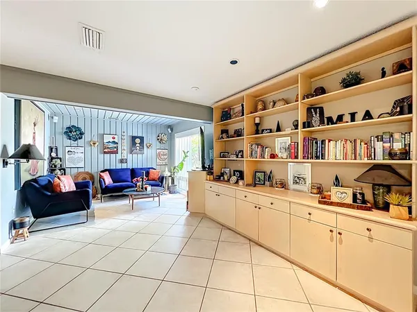 a room with furniture a rug toys and a window