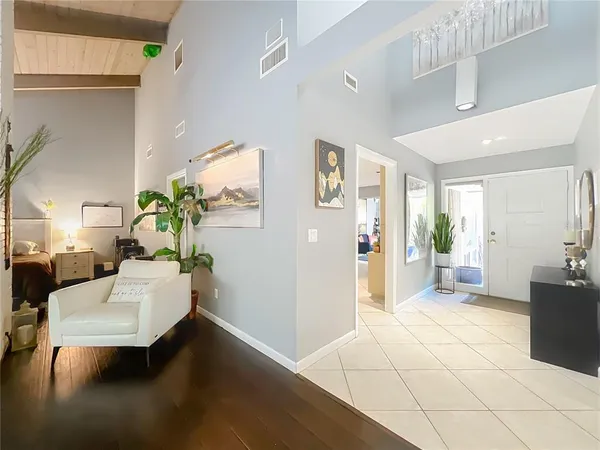 a living room with furniture and a potted plant
