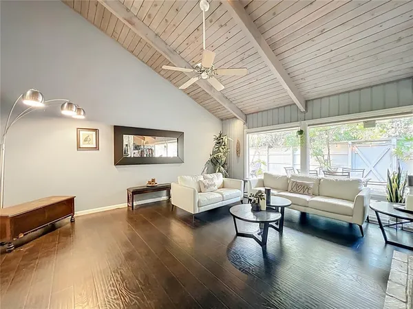 a living room with furniture and a wooden floor