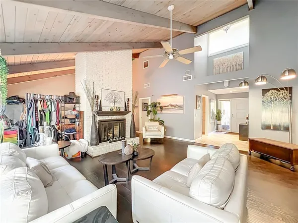 a living room with furniture a flat screen tv and a large window
