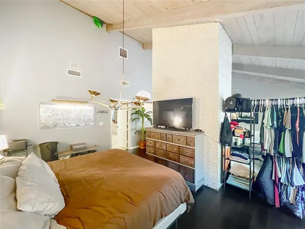 a bedroom with a bed and a flat screen tv